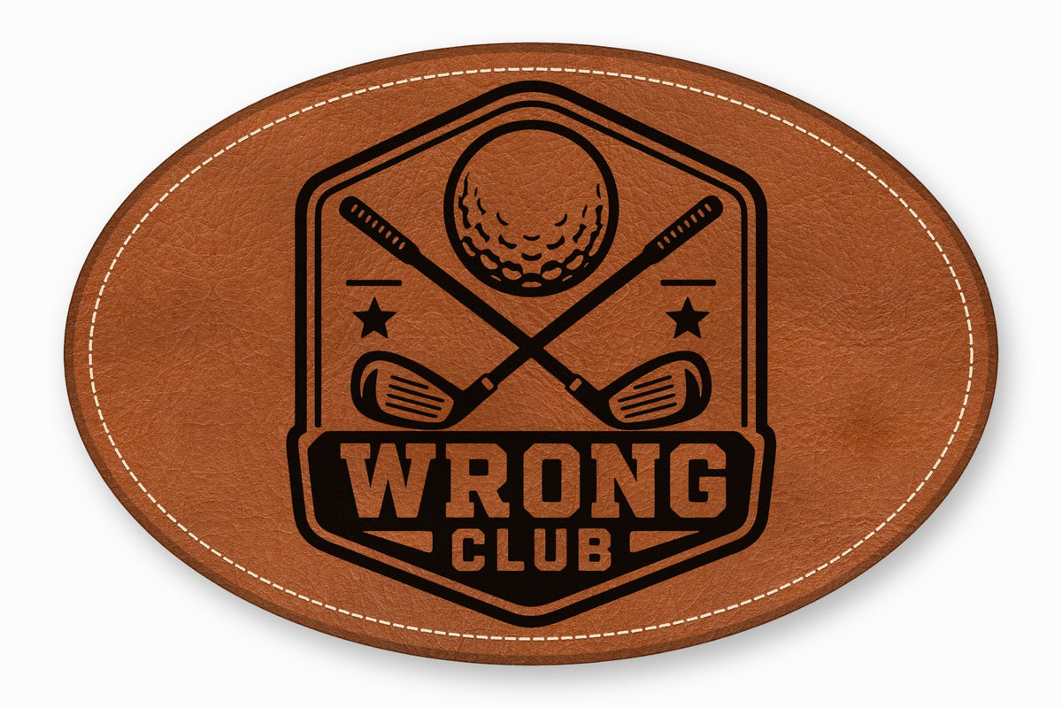 An oval brown leather patch with white stitched border featuring a black golf emblem and text reading WRONG CLUB.