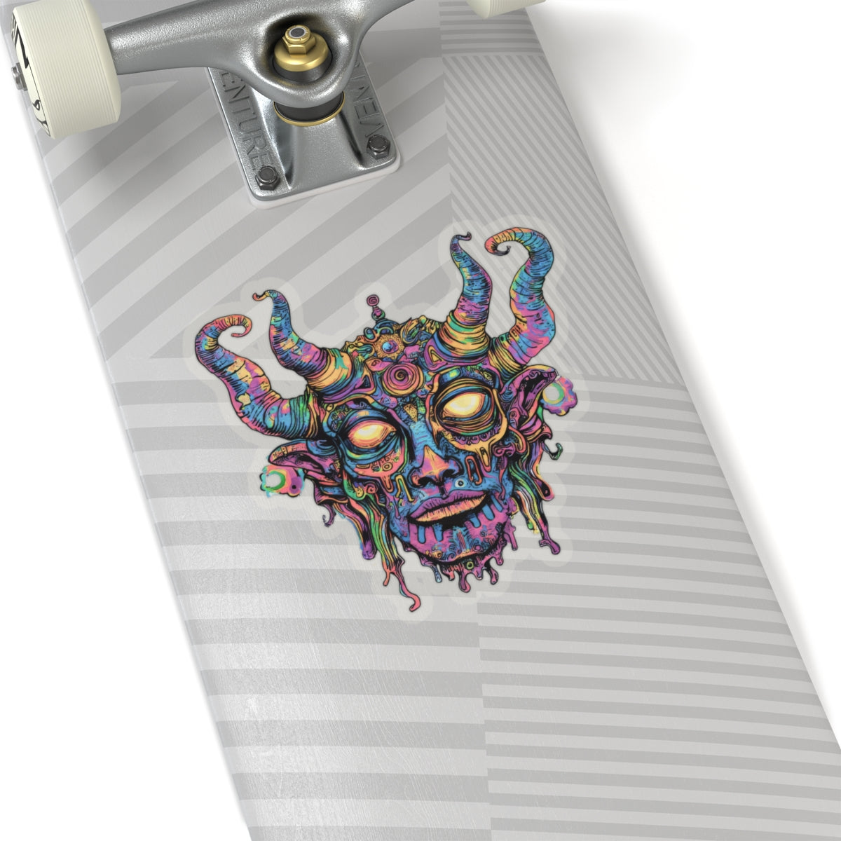 Colorful psychedelic demon face sticker on a skateboard deck.