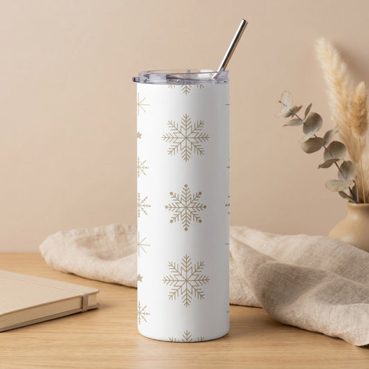 White tumbler with gold snowflake pattern and silver straw.