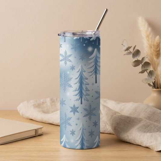 Blue tumbler with white snowflakes and pine trees, featuring a metal straw.