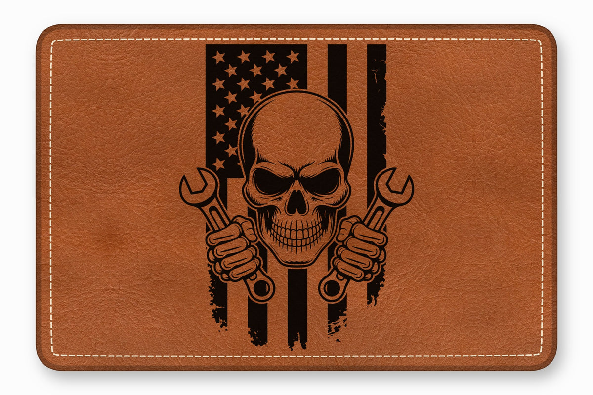 Brown leather patch with rounded corners, white stitching, and a black skull and wrench American flag graphic.