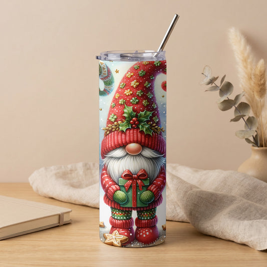 Tall tumbler with a Christmas gnome holding a gift, festive patterns, and a metal straw.