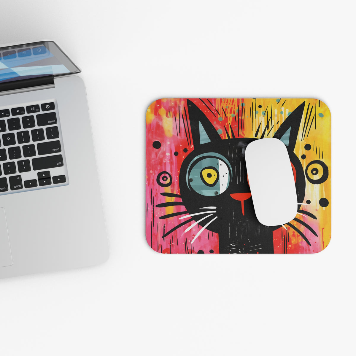Abstract mousepad with a black cat illustration and colorful paint splatters.