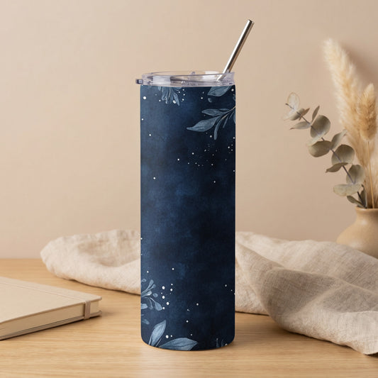 Navy blue skinny tumbler with white floral and dot pattern and metal straw.