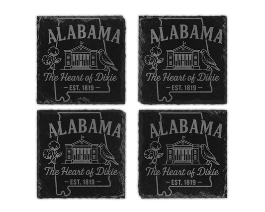 Four Alabama slate coasters with outline, state name, building, bird, cotton, and text.