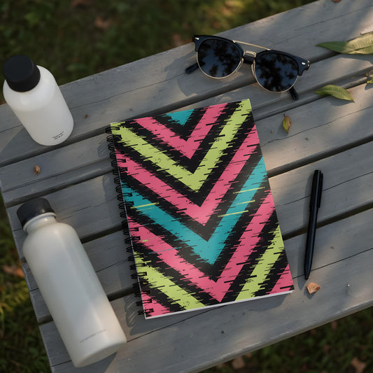 Spiral notebook with a chevron pattern in pink, teal, and yellow.