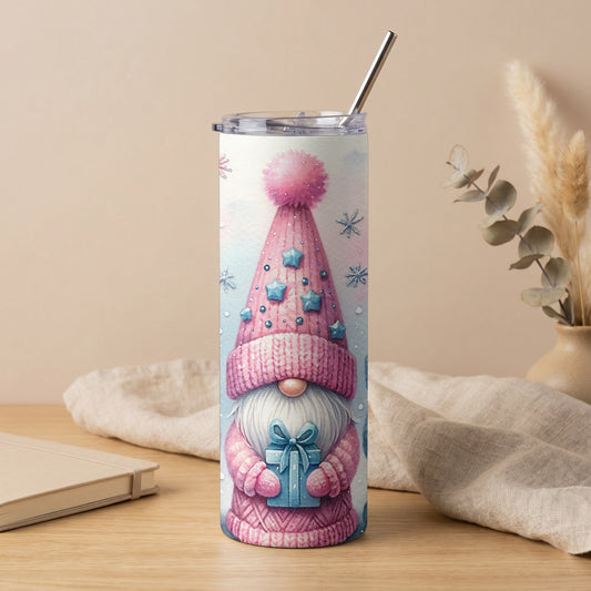 Tumbler with pink gnome holding a blue gift, decorated with stars and snowflakes.