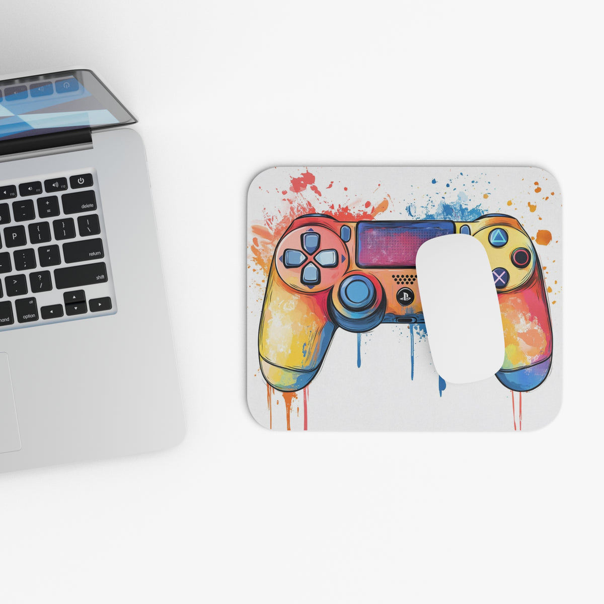 Mousepad with colorful, dripping watercolor game controller design and a white mouse.