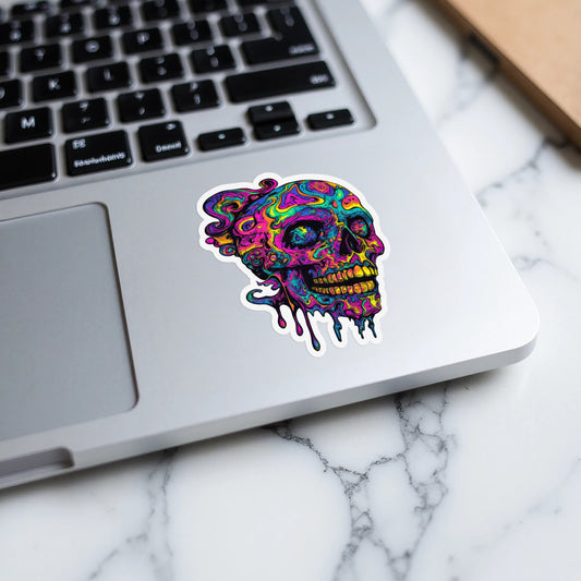 Melting psychedelic skull sticker on a laptop keyboard.
