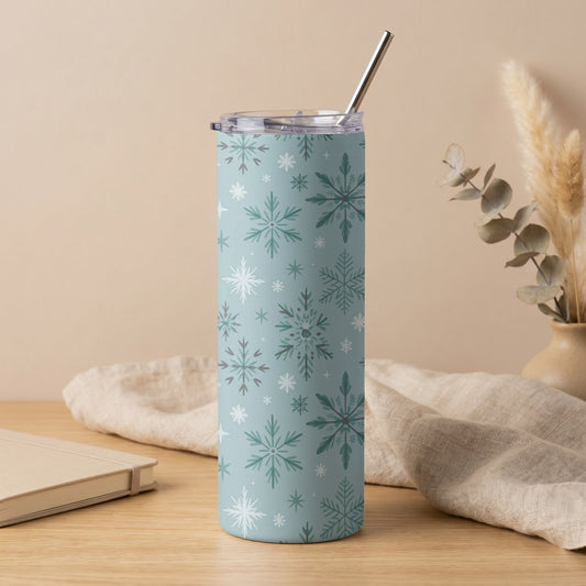 Blue tumbler with white and green snowflake pattern and metal straw.