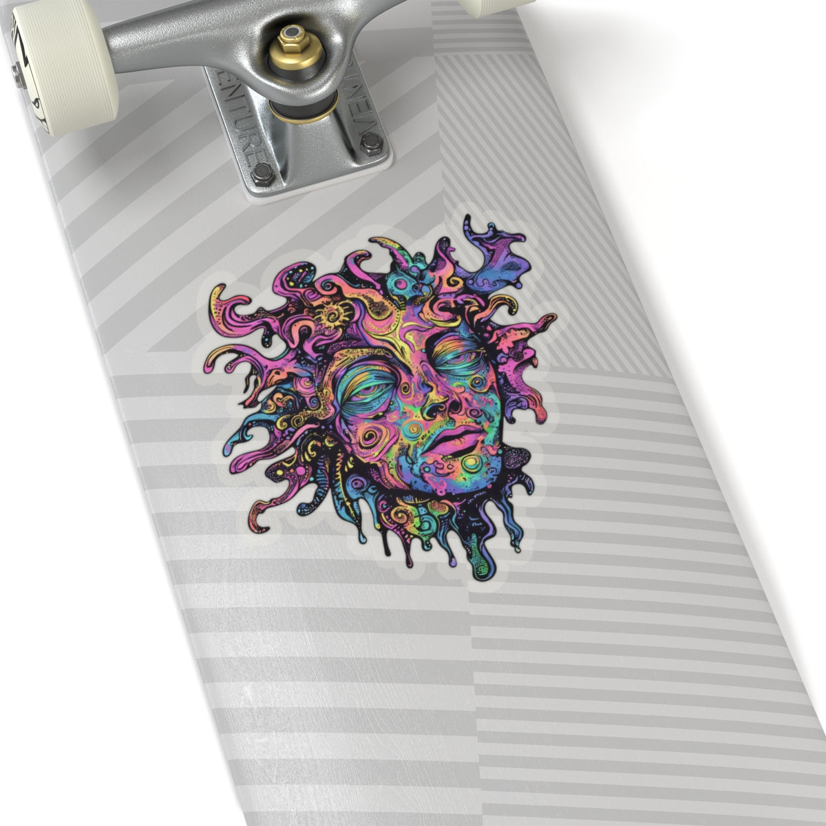 Psychedelic sun face sticker on a skateboard deck with grey stripes.