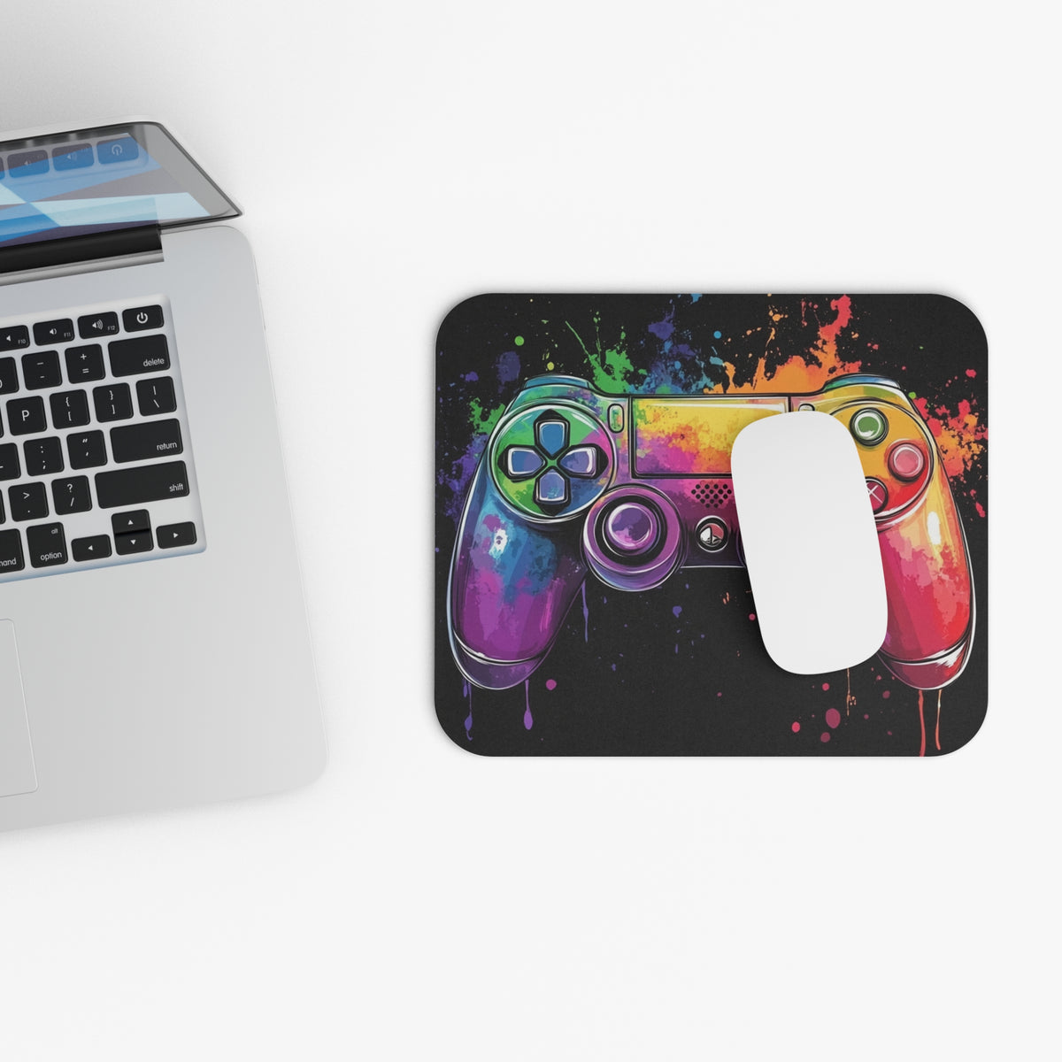 Mousepad with colorful watercolor game controller design and a white mouse.