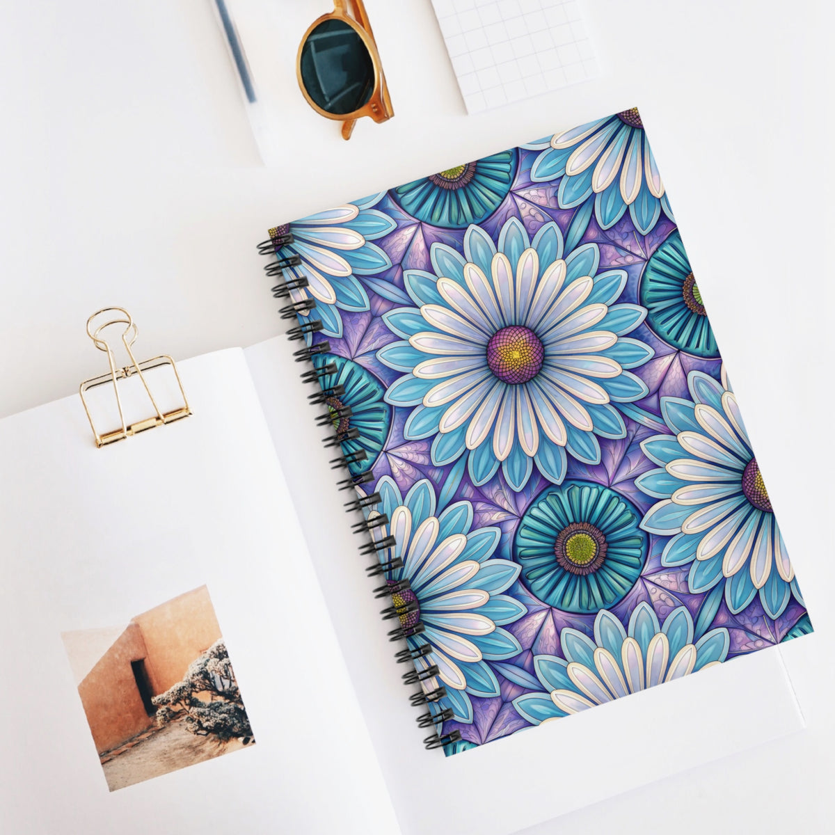 Spiral notebook with blue, purple, and white floral mandala design.
