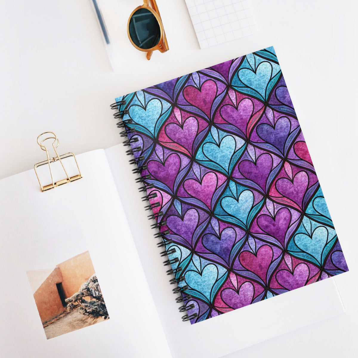 Spiral-bound notebook with a stained-glass heart pattern in purple and blue hues.