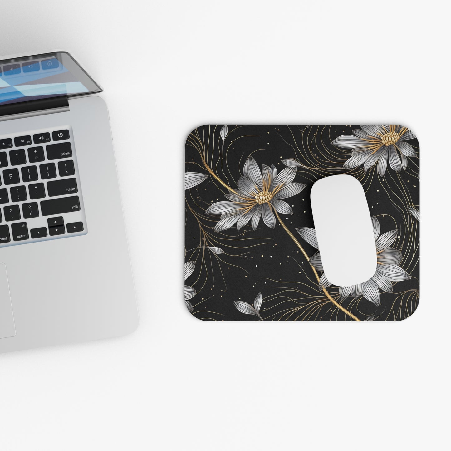 Black mousepad with silver and gold floral design and white mouse