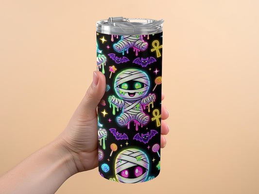 Tumbler with black background, cartoon mummies, bats, lollipops, and stars pattern.