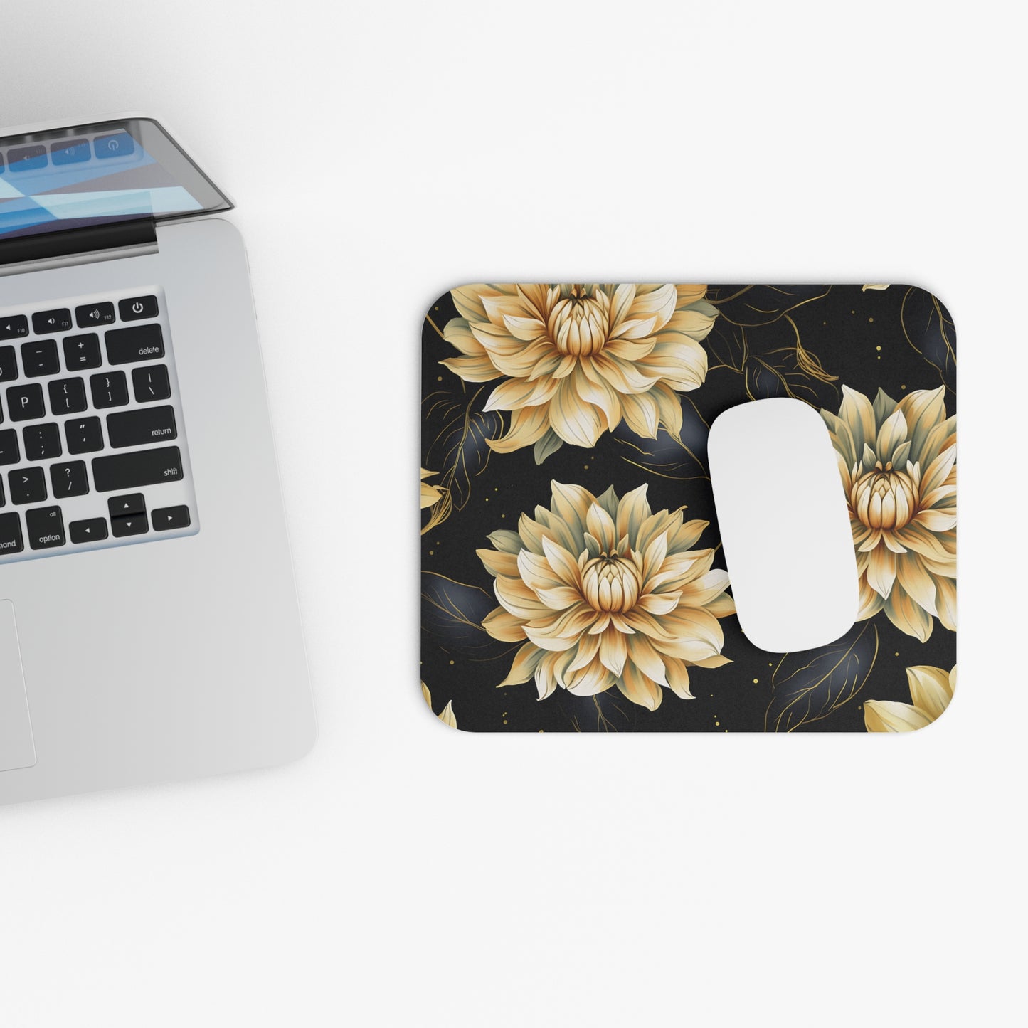 Mousepad with a gold and cream floral pattern on a black background.