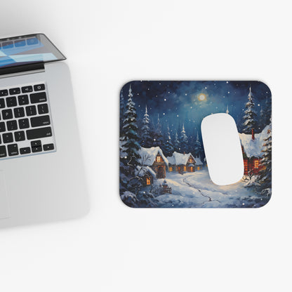 Mousepad with painted winter village scene and snow-covered evergreen trees.