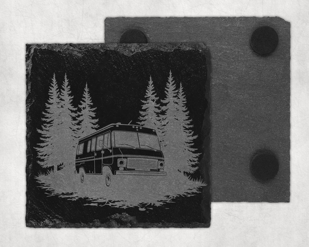 Slate coaster with engraved RV in a forest scene and a second coaster behind.