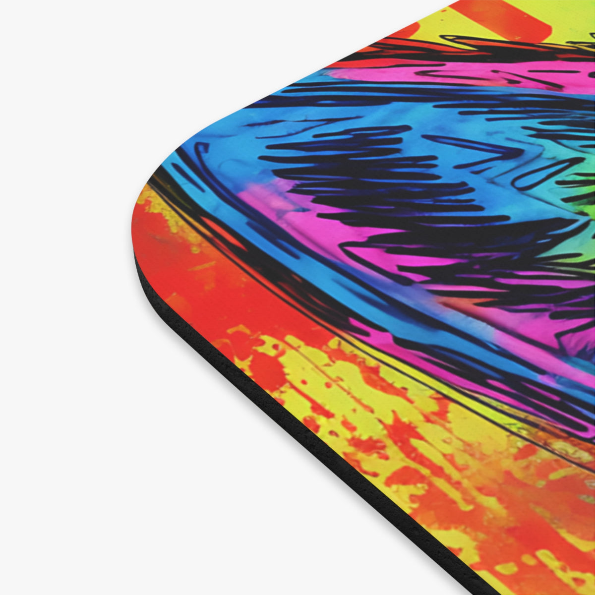 Close-up corner of a mousepad featuring a vibrant abstract design with bold black strokes against colorful backgrounds.
