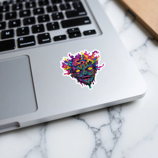 Psychedelic melting face sticker with vibrant colors on a laptop.