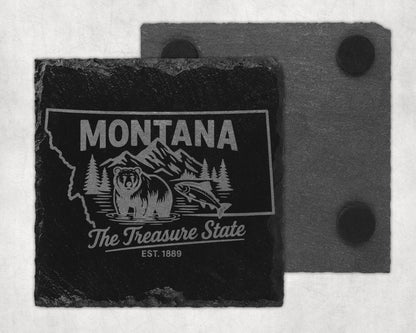 Montana state map etched on a dark slate coaster with bear, fish, and mountains.