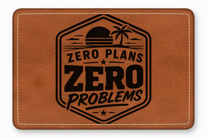 Brown leather patch with rounded corners, white stitching, and a black tropical sunset emblem containing the text Zero Plans Zero Problems.