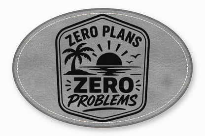 Gray oval leather patch with white stitched border and black "Zero Plans Zero Problems" tropical sunrise graphic.