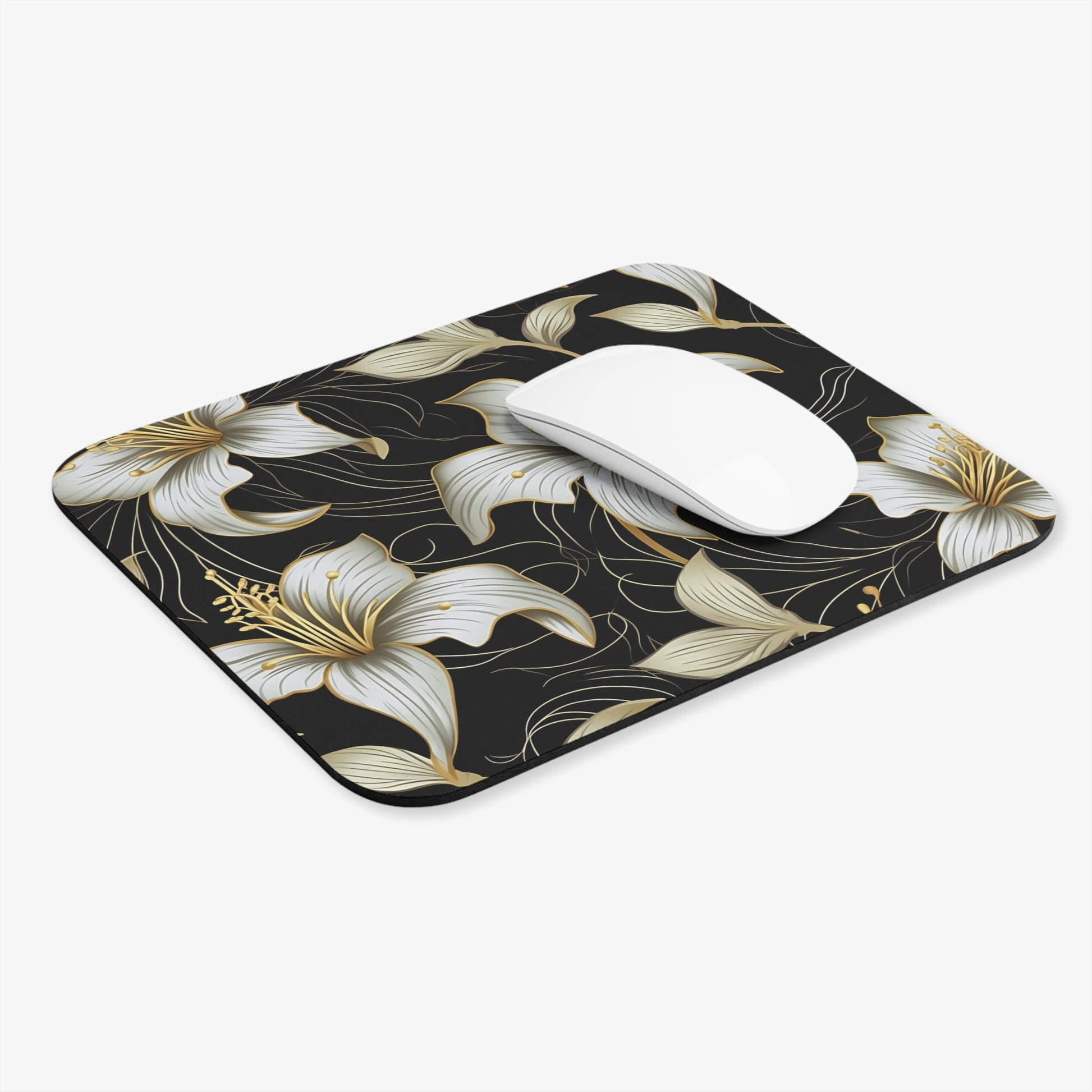 Black mousepad with white and gold floral pattern and a white mouse.