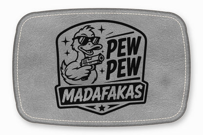 Grey rectangular leather patch with white stitched border and a black graphic of a duck holding a gun with the text PEW PEW MADAFAKAS.
