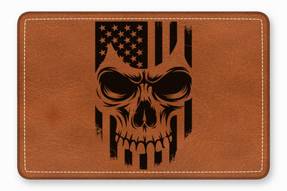 Brown rectangular leather patch with rounded corners, featuring a black laser-engraved American flag skull design and white stitching.