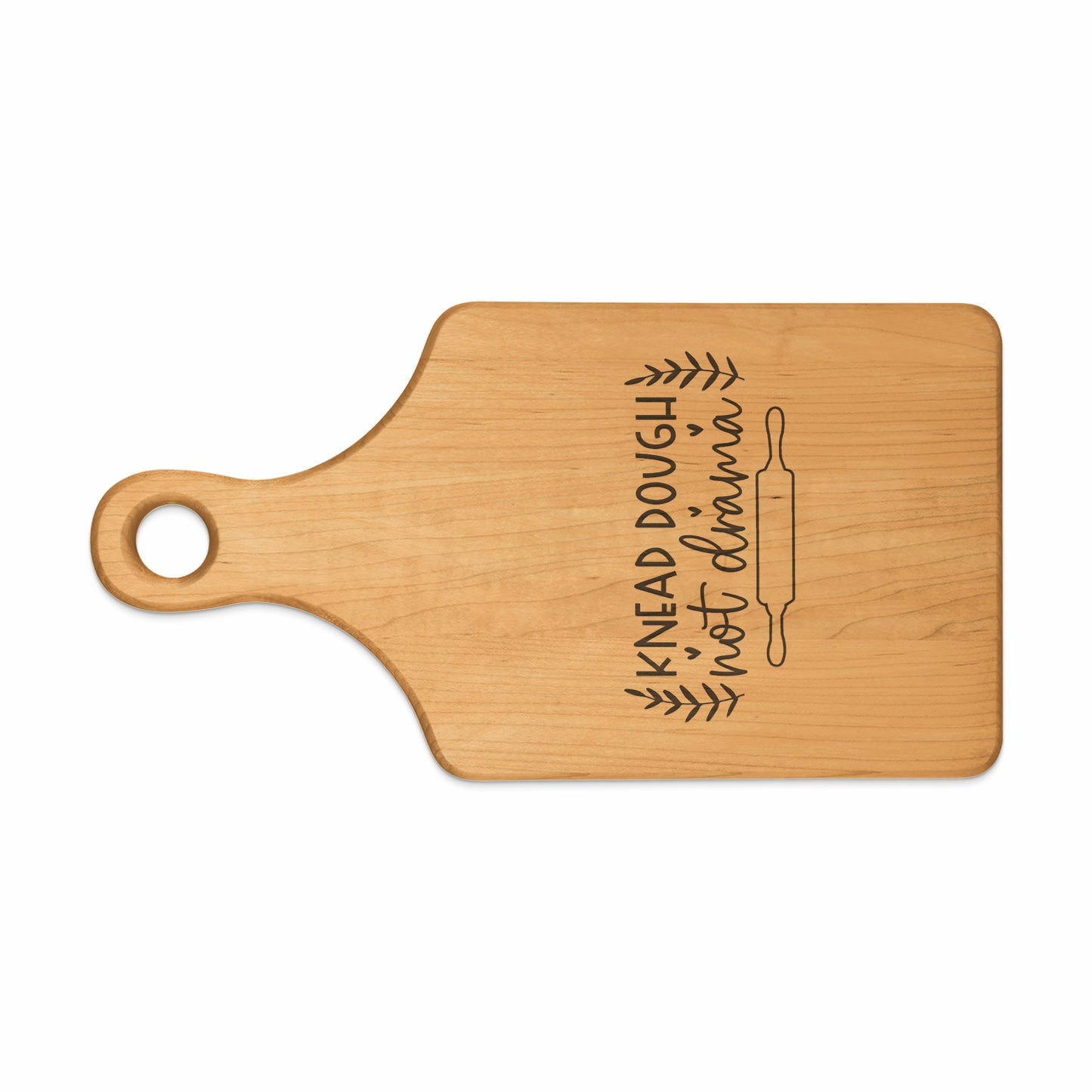 Wooden cutting board with "Knead Dough, Not Drama" and rolling pin design.