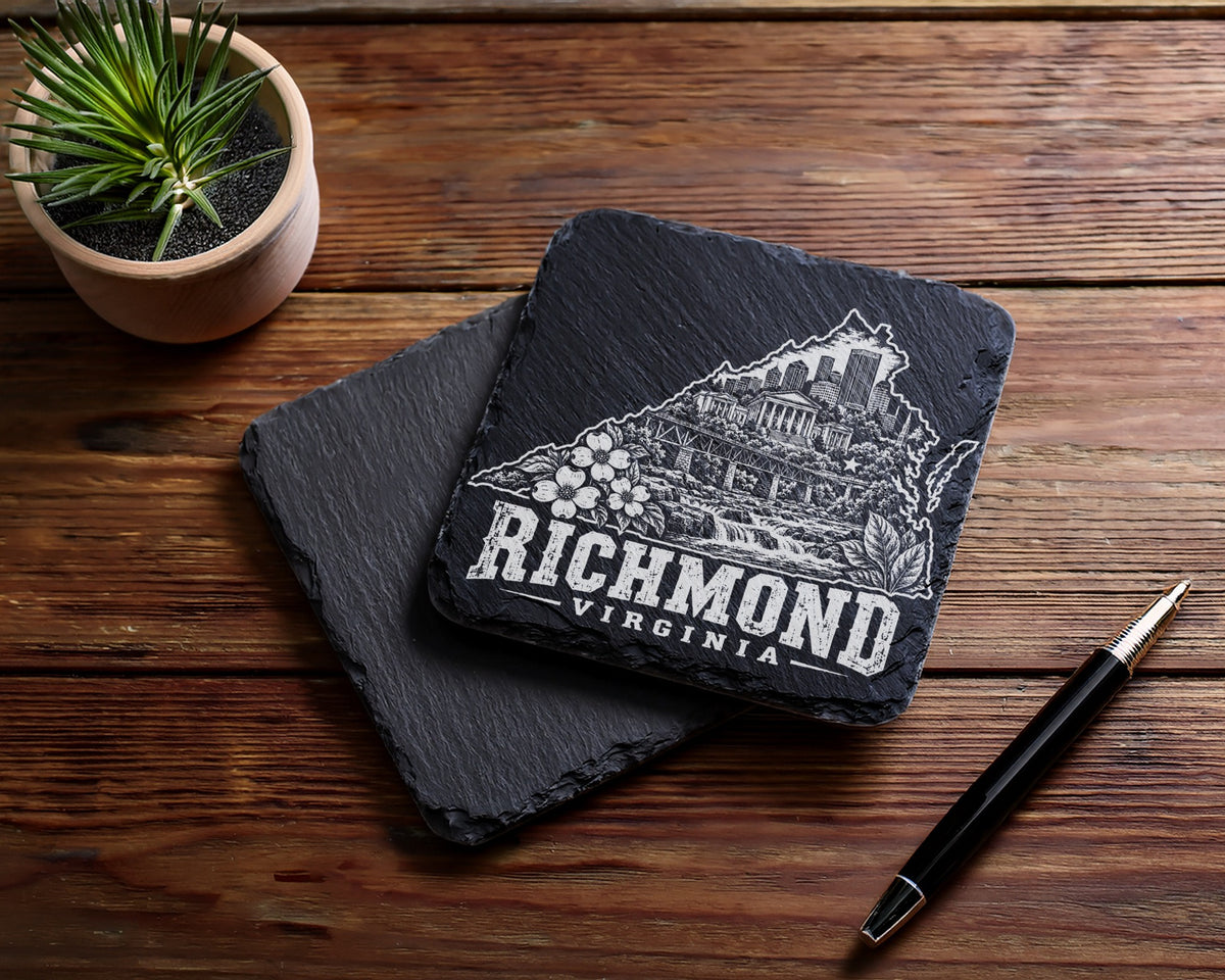 Two square black slate coasters with Richmond Virginia engravings rest on a wooden table.