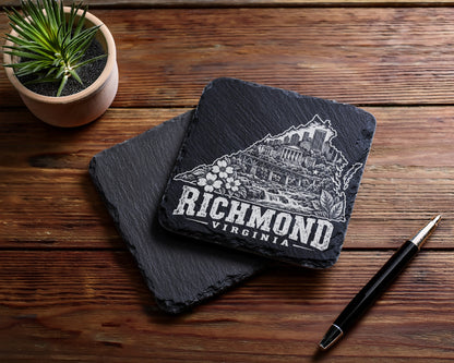 Two square black slate coasters with Richmond Virginia engravings rest on a wooden table.