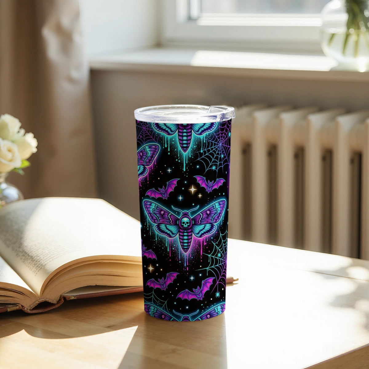 Tumbler with a dark background featuring neon moths, bats, and spiderwebs.