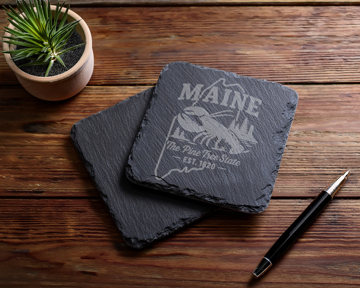 Two slate coasters with Maine lobster and "The Pine Tree State EST. 1820" engraving.