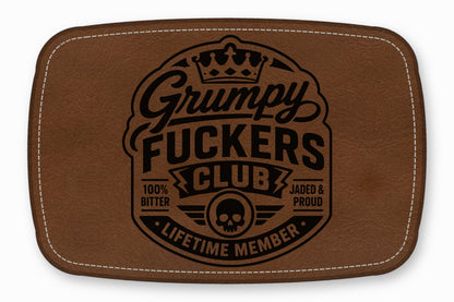Brown faux leather patch with white stitched border and a black Grumpy Fuckers Club logo.
