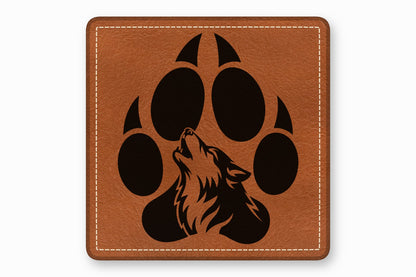 Square brown leather patch with white stitched border and a black wolf howling graphic inside a paw print.
