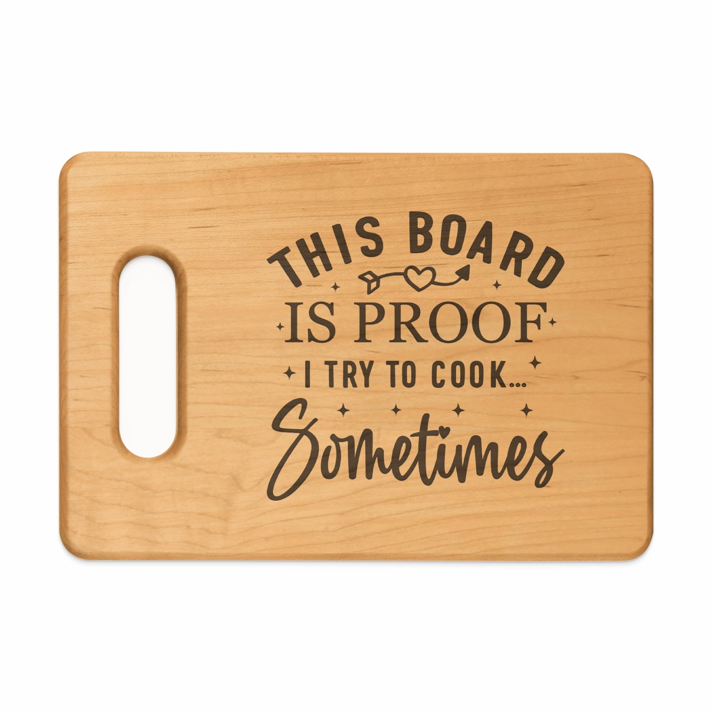Wooden cutting board with text "This board is proof I try to cook... Sometimes".