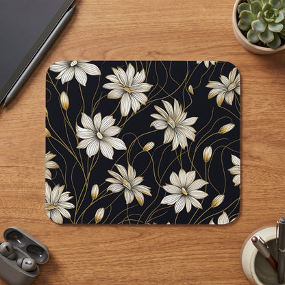 Mousepad with a dark background and a pattern of white flowers with gold accents.