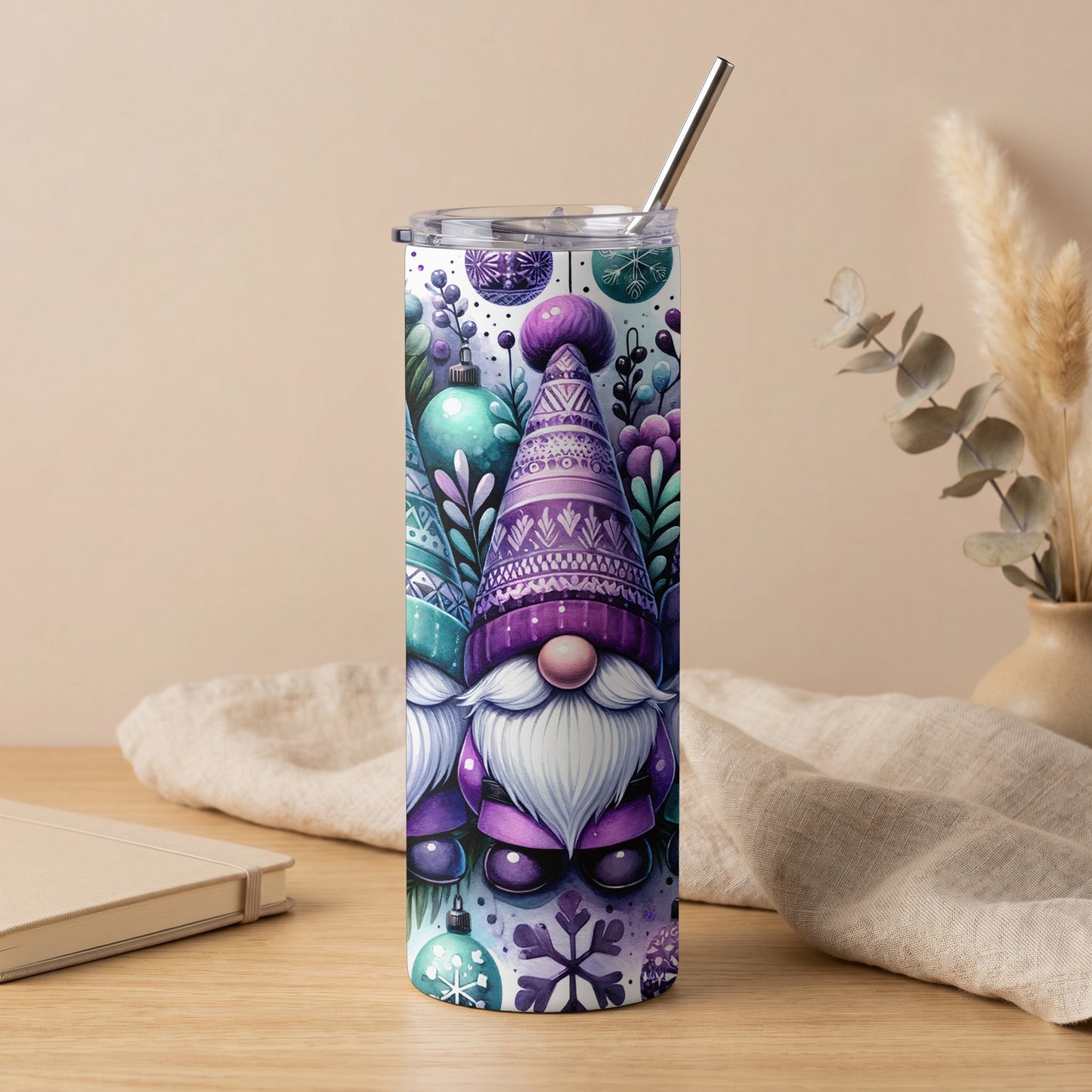 Purple gnome and snowflake design on a tall tumbler with a metal straw.
