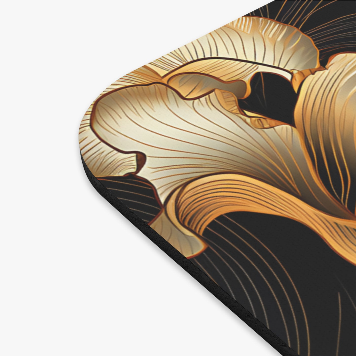 Close-up of a black mousepad with a flowing gold abstract floral design.