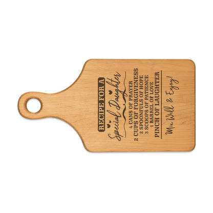 Wooden cutting board with "Recipe for a Special Daughter" and ingredients.