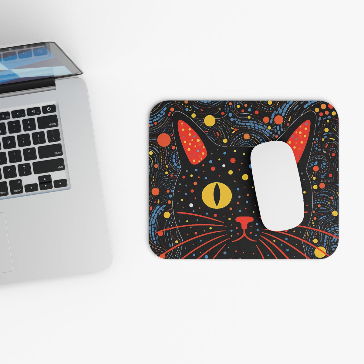 Mousepad with a black cat face and colorful abstract pattern.