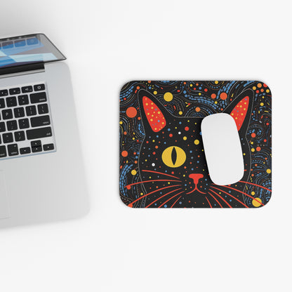 Mousepad with a black cat face and colorful abstract pattern.