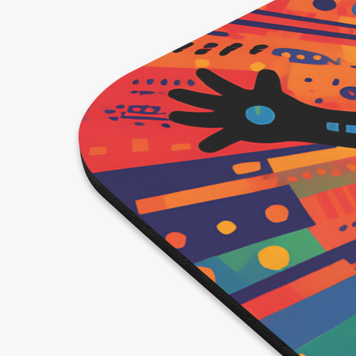 Close-up of a rounded rectangular mouse pad featuring a colorful abstract art print with a black hand silhouette.