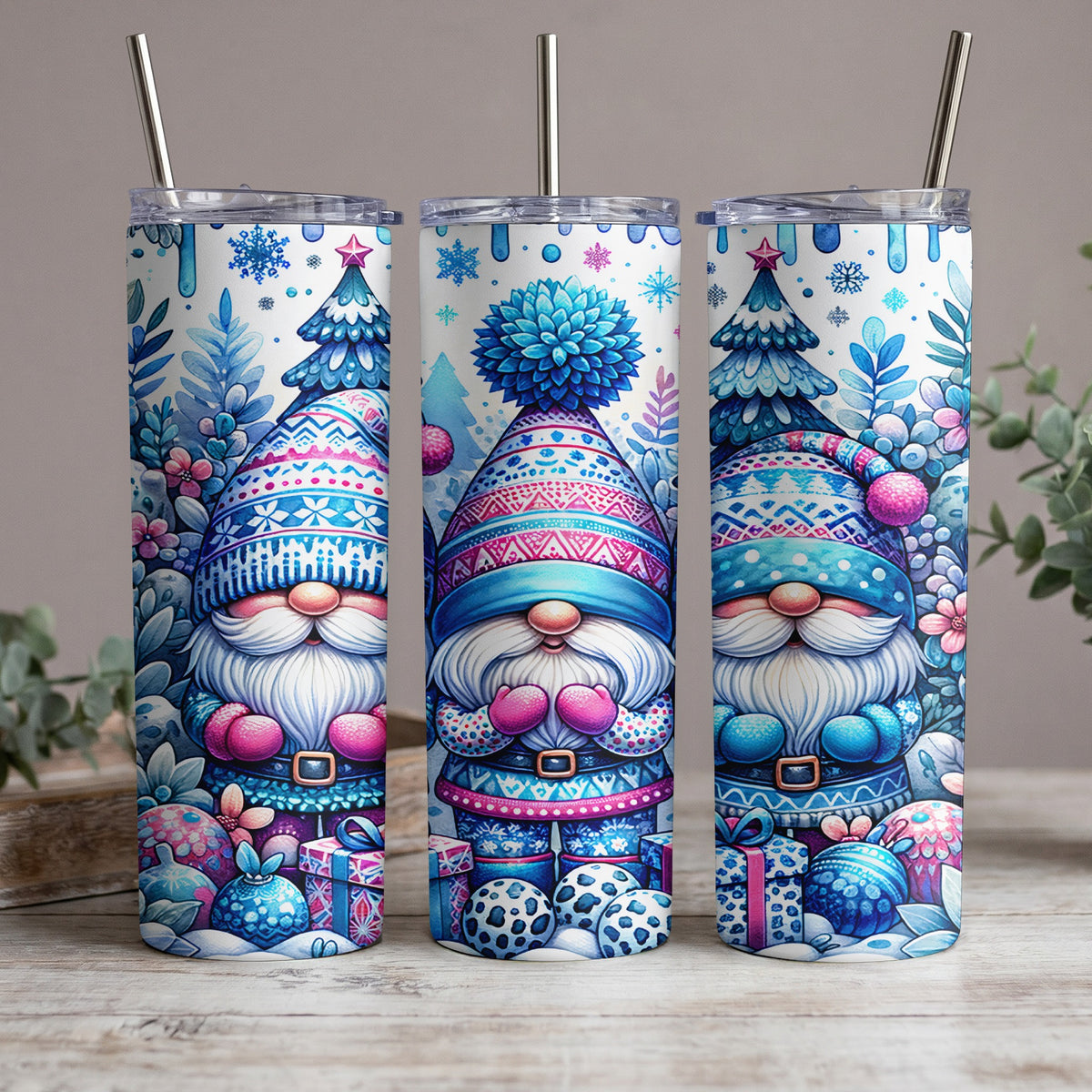Three tumblers featuring a blue and pink Christmas gnome in a patterned hat and clothing.