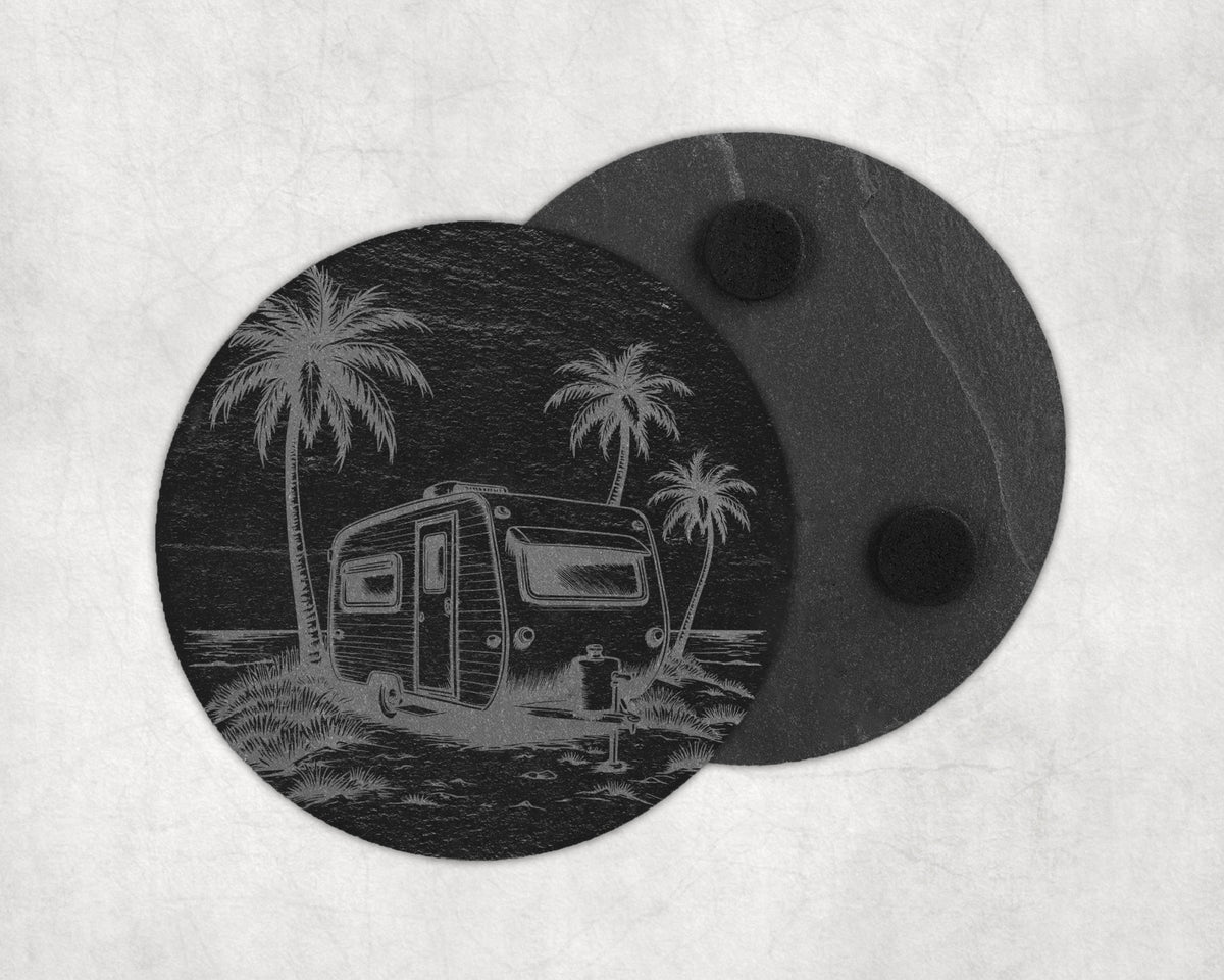 Round slate coaster with etched image of a vintage caravan and palm trees by the sea.