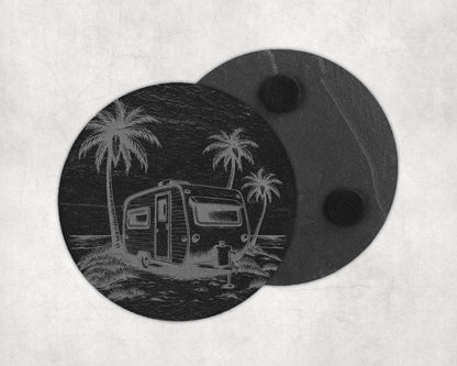 Round slate coaster with etched image of a vintage caravan and palm trees by the sea.