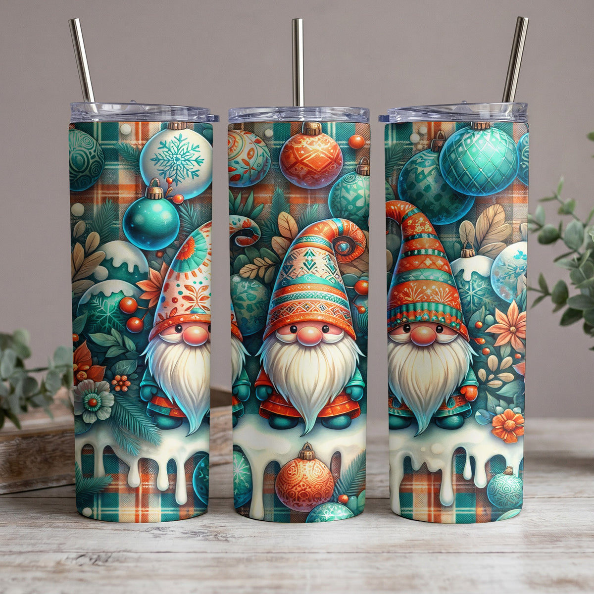 Three tumblers with a Christmas gnome design featuring plaid, ornaments, and snow.